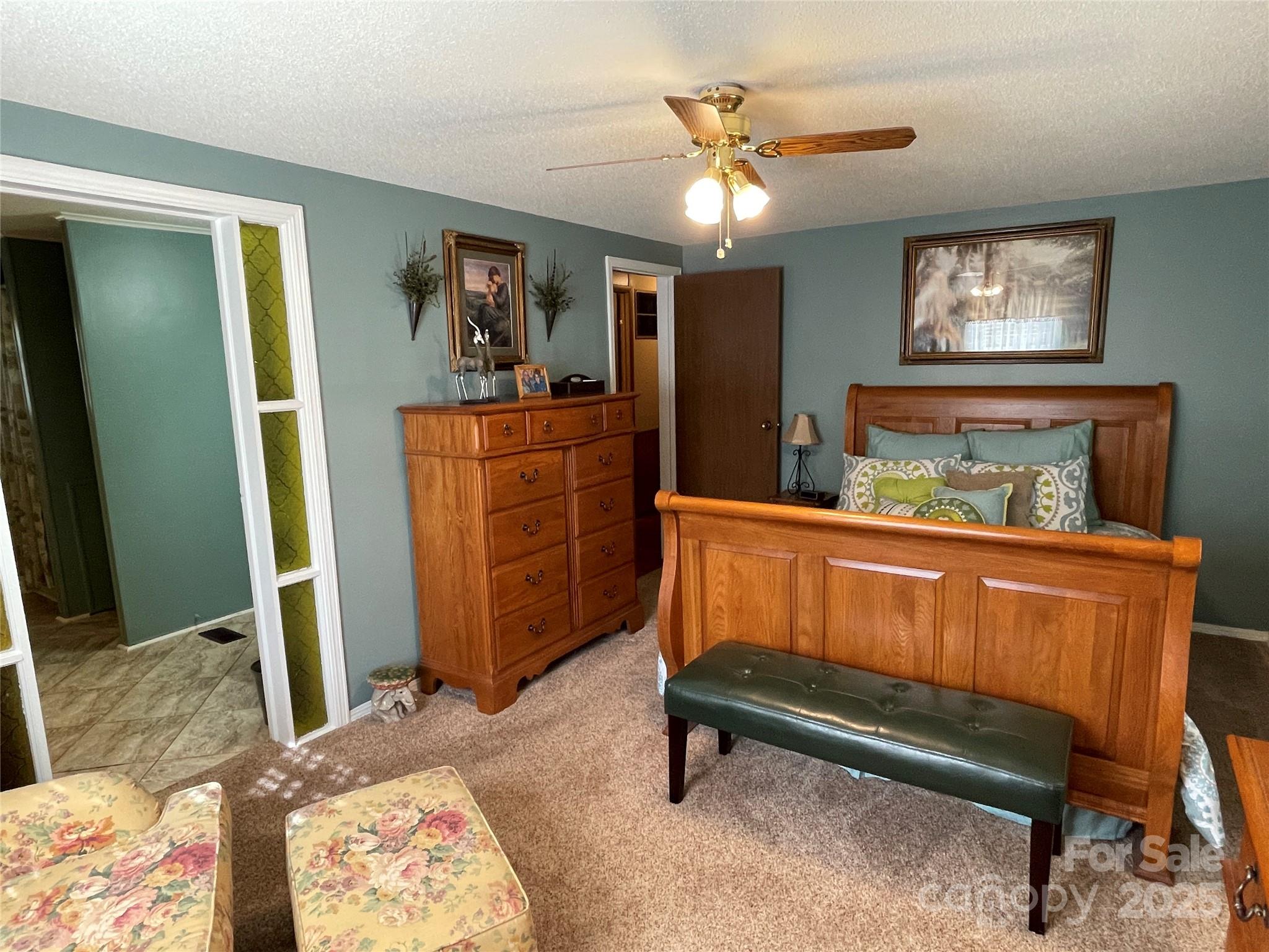3403 Beaty Road Gastonia, NC 28056 - Photo 22 of 40 a bedroom with a bed and a chandelier
