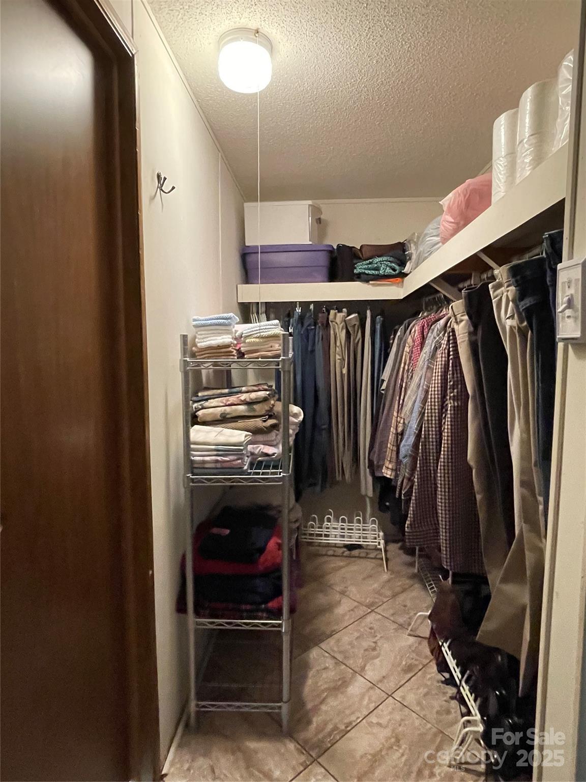 3403 Beaty Road Gastonia, NC 28056 - Photo 26 of 40 a view of walk in closet with clothes and shoes