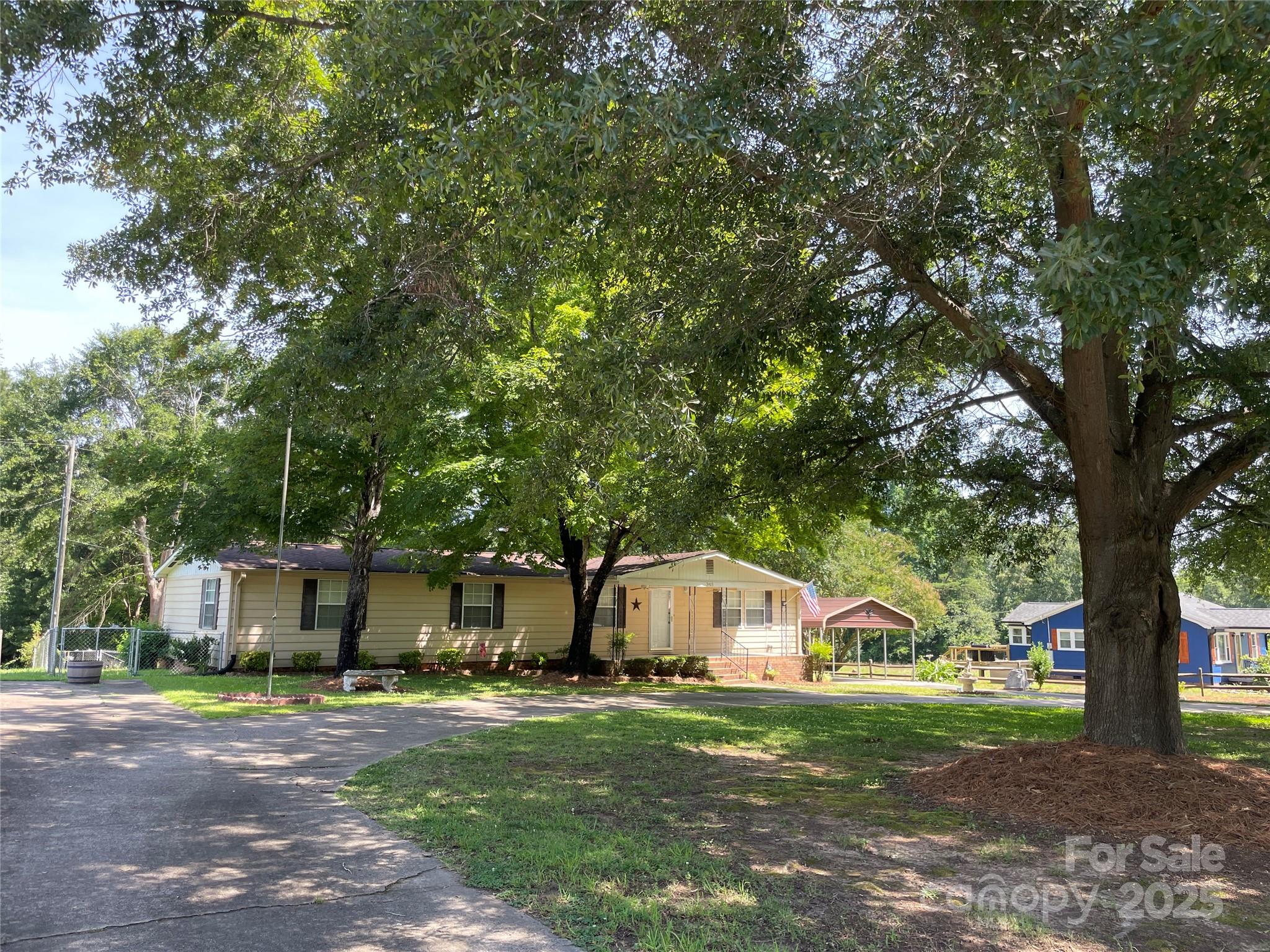 3403 Beaty Road Gastonia, NC 28056 - Photo 4 of 40 a front view of a house with a garden and trees