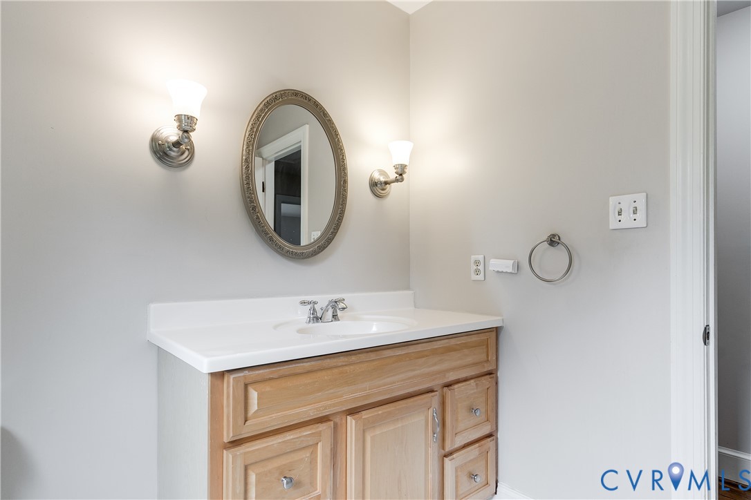 3924 Belspring Road Chester, VA 23831 - Photo 24 of 36 Single vanity featuring a light wood-finish cabine