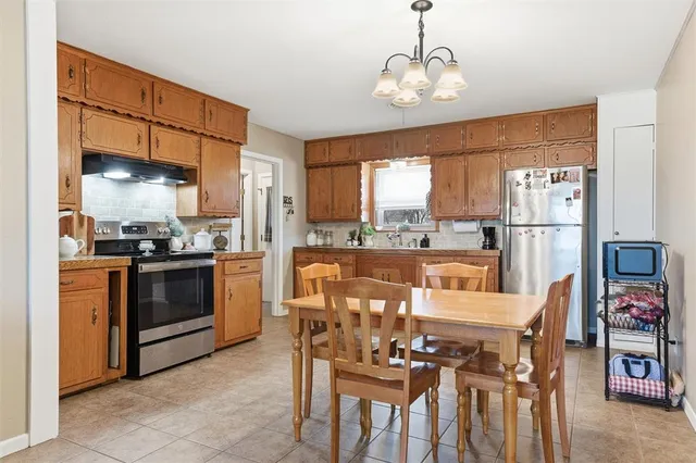 a large kitchen with a table and chairs