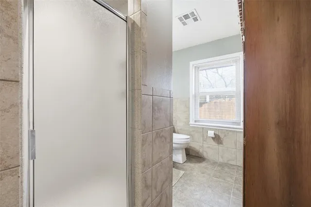 a bathroom with a toilet sink and a window