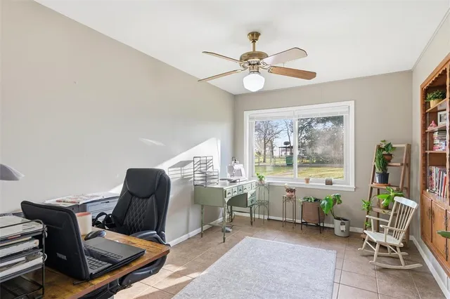 a view of a workspace with furniture and a window