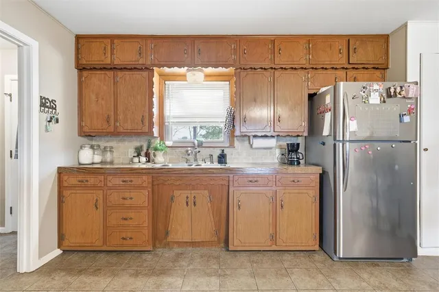 a kitchen with stainless steel appliances a refrigerator and a sink