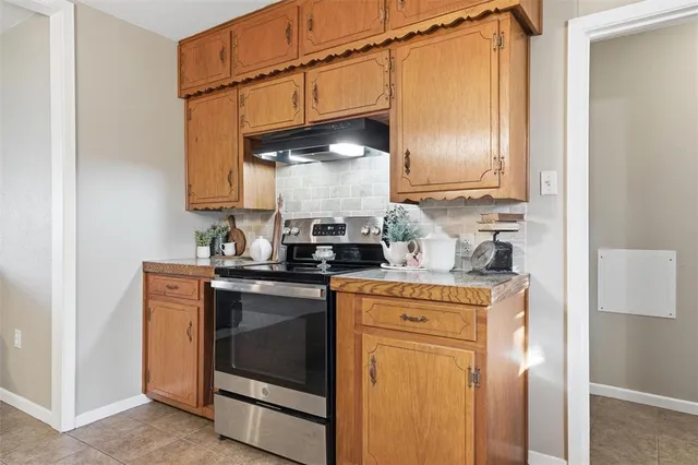 a kitchen with stainless steel appliances granite countertop a refrigerator and a stove