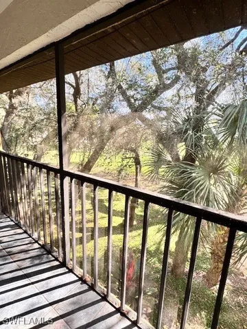 a view of a balcony with wooden floor
