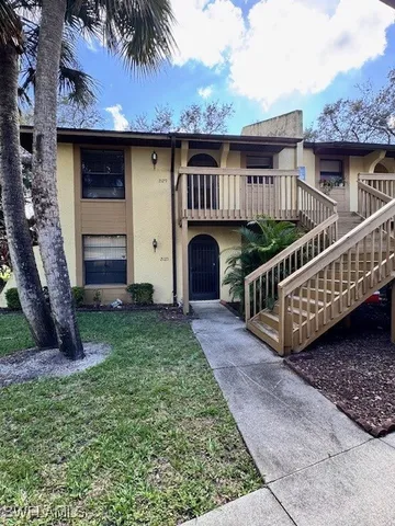 a front view of a house with garden and deck