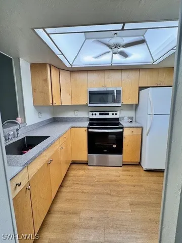 a kitchen with stainless steel appliances a stove sink and cabinets