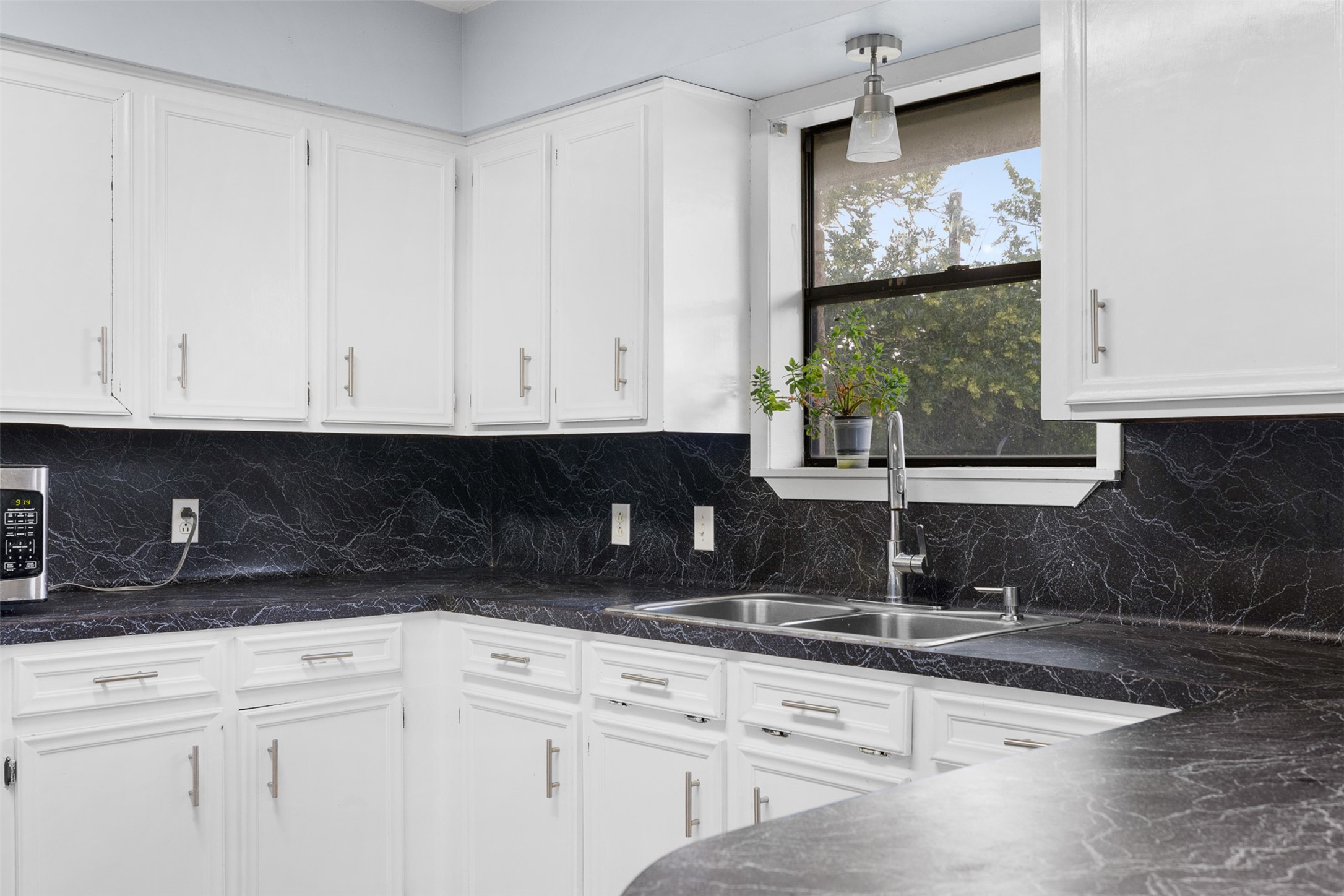 1015 FM 112 Road Lexington, TX 78947 - Photo 19 of 38 a kitchen with stainless steel appliances granite countertop white cabinets and a sink