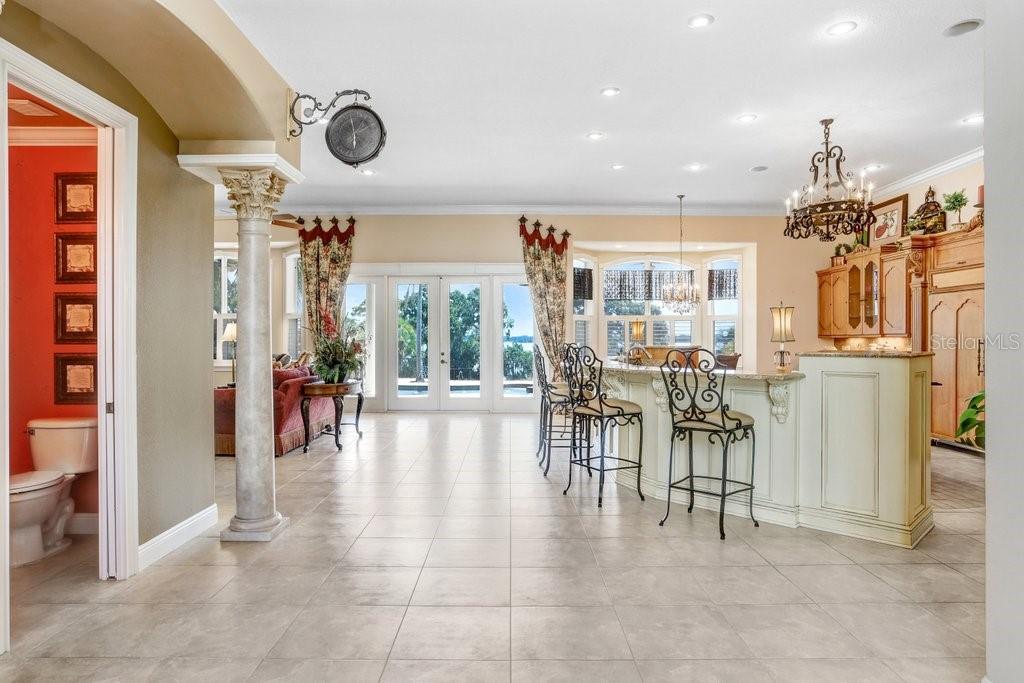 11715 Taylor Road Thonotosassa, FL 33592 - Photo 11 of 73 a view of a a dining room with furniture a chandelier and a large window