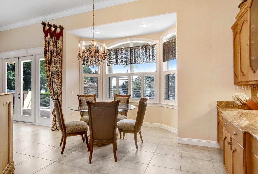 11715 Taylor Road Thonotosassa, FL 33592 - Photo 14 of 73 a view of a dining room with furniture large windows and wooden floor