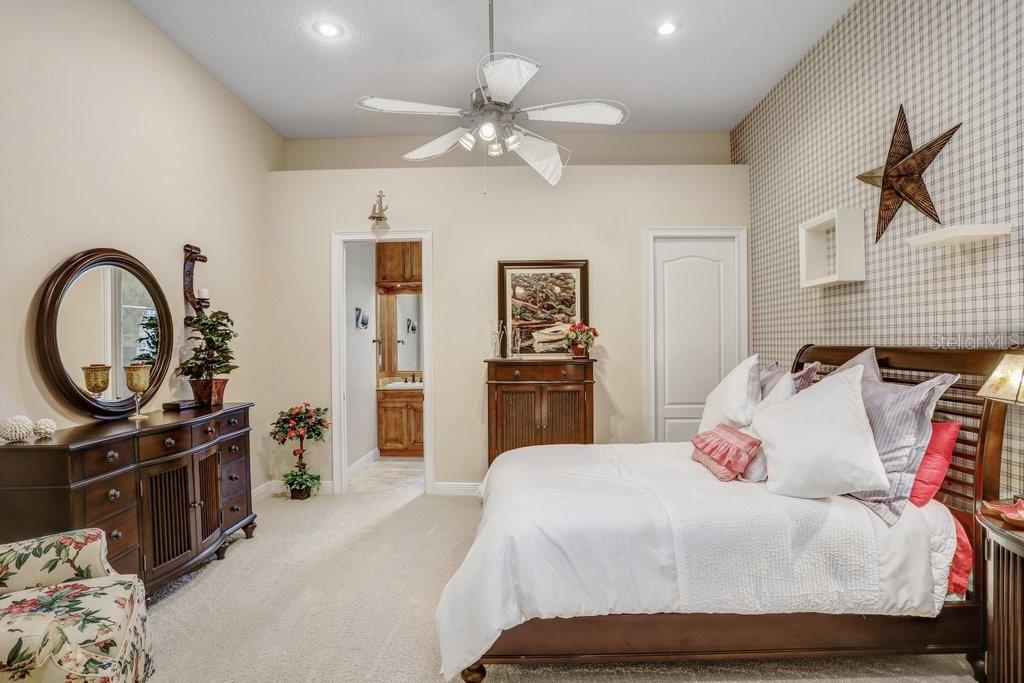 11715 Taylor Road Thonotosassa, FL 33592 - Photo 29 of 73 a bedroom with a bed and a chandelier