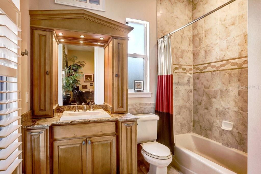 11715 Taylor Road Thonotosassa, FL 33592 - Photo 33 of 73 a bathroom with a granite countertop sink toilet and shower