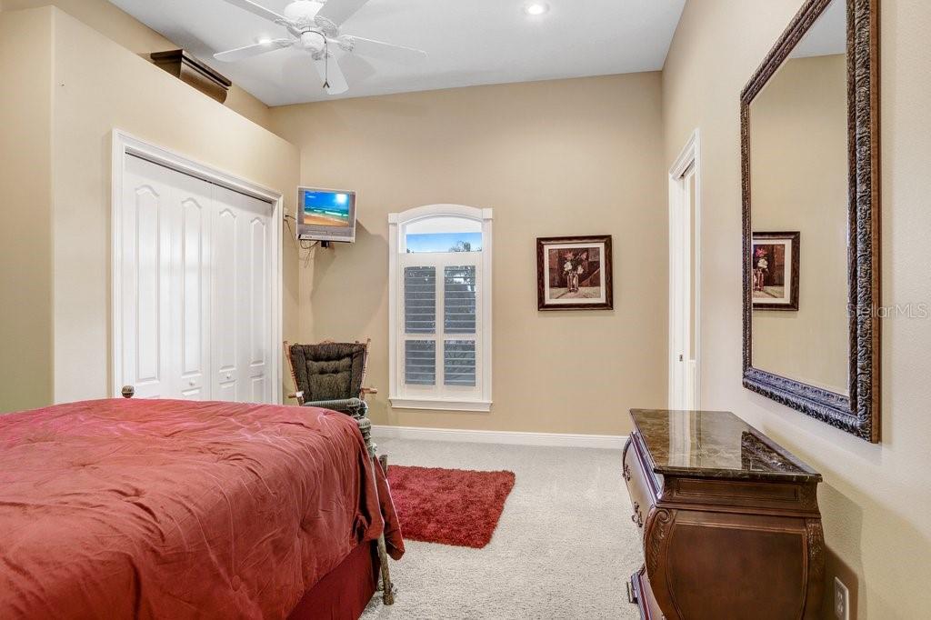 11715 Taylor Road Thonotosassa, FL 33592 - Photo 38 of 73 a bedroom with a bed and wooden floor