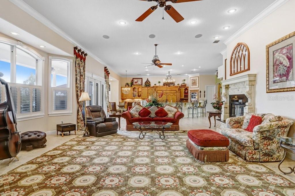 11715 Taylor Road Thonotosassa, FL 33592 - Photo 43 of 73 a living room with furniture a rug and a chandelier