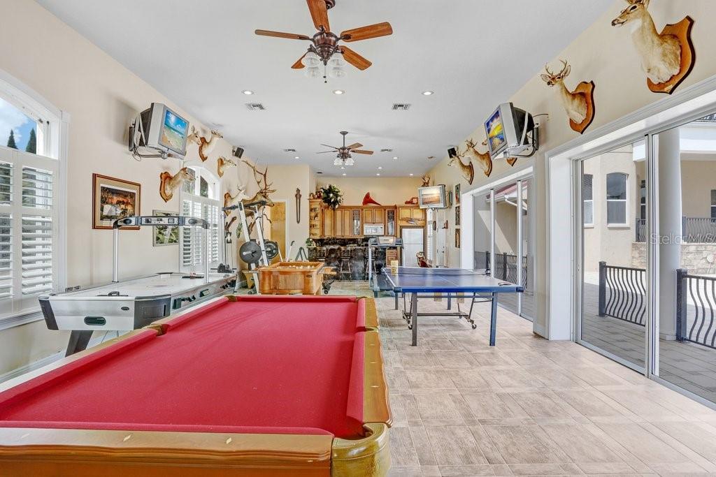 11715 Taylor Road Thonotosassa, FL 33592 - Photo 51 of 73 a room with lots of white furniture and a chandelier