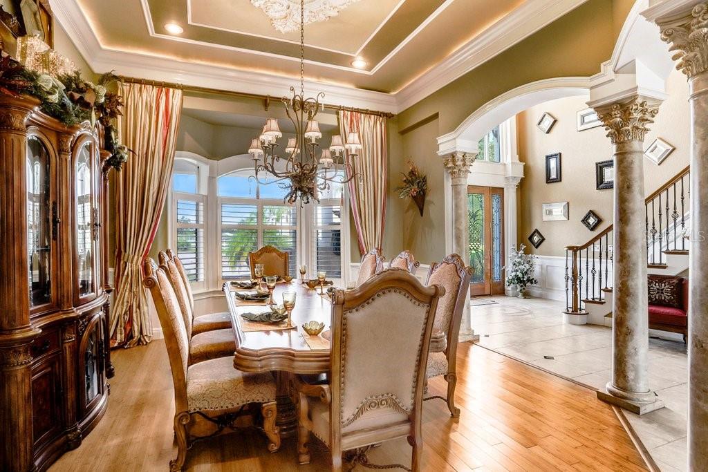 11715 Taylor Road Thonotosassa, FL 33592 - Photo 9 of 73 a view of a dining room with furniture wooden floor and a chandelier
