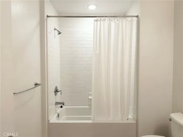 a bathroom with a sink vanity mirror and toilet