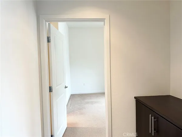 an empty room with sliding glass door and shower
