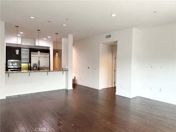 a view of a kitchen with wooden floor and a sink