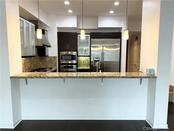 a kitchen with stainless steel appliances a refrigerator and a sink
