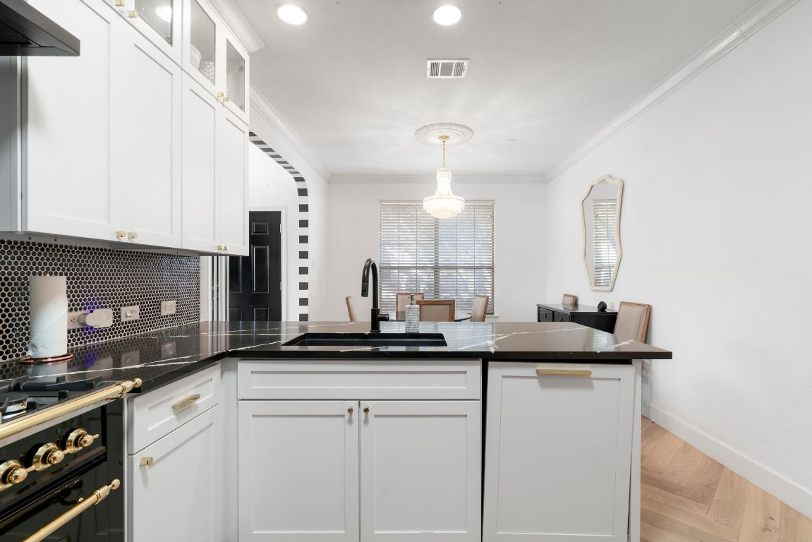 9201 Brodie Lane, Unit 2303 Austin, TX 78748 - Photo 11 of 26 a kitchen with a sink and cabinets