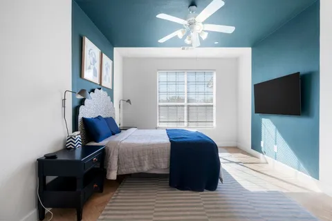 a bedroom with a bed and a flat screen tv