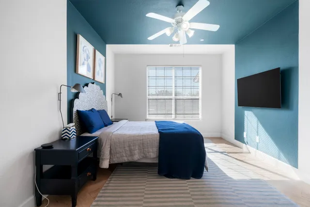 a bedroom with a bed and a flat screen tv