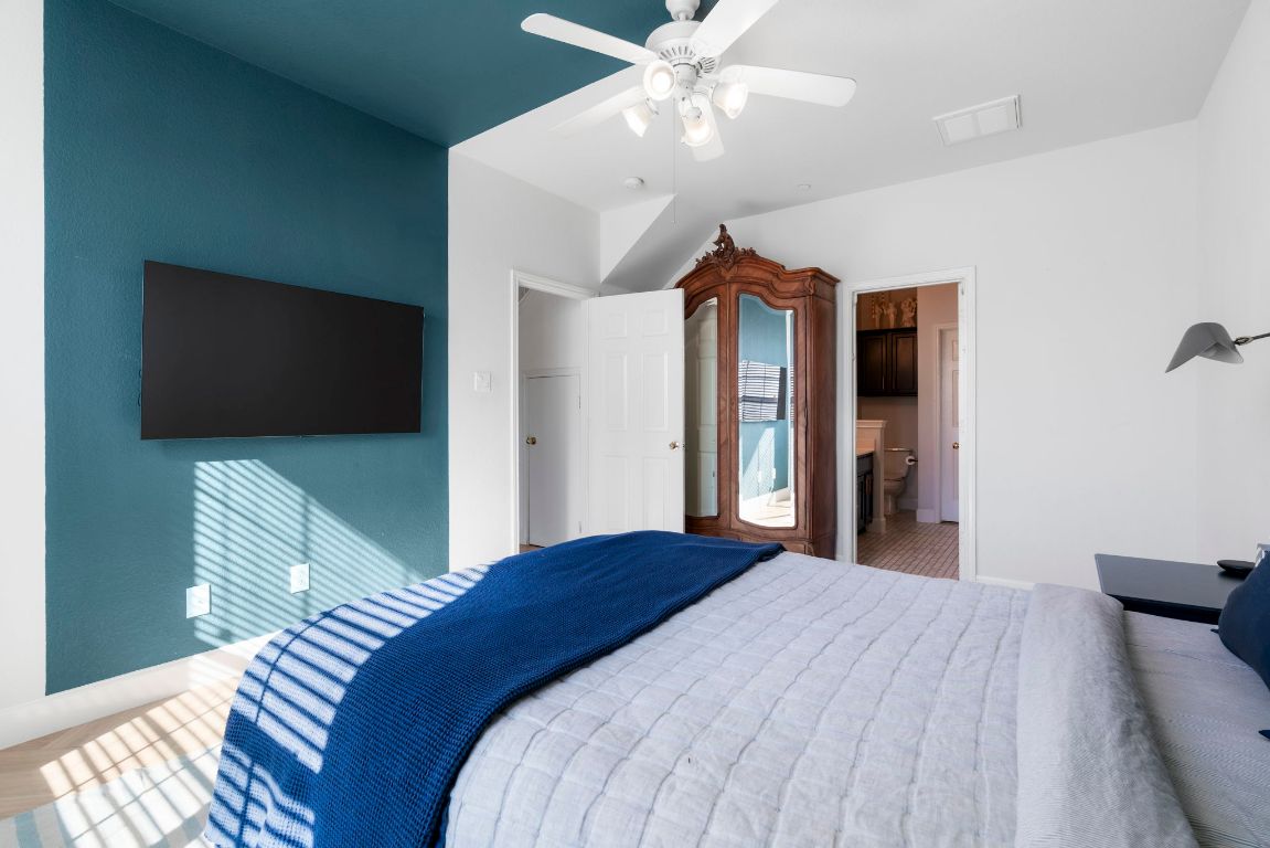 9201 Brodie Lane, Unit 2303 Austin, TX 78748 - Photo 15 of 26 a bedroom with a bed and a flat screen tv