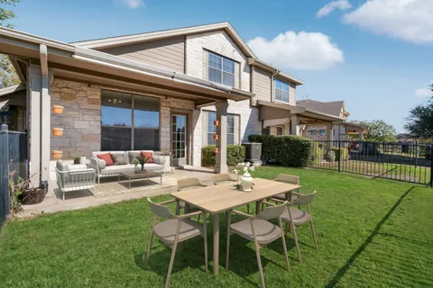 a view of a house with backyard sitting area and garden