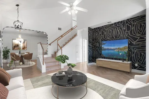 a living room with furniture and a potted plant