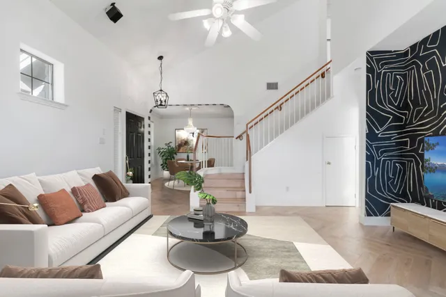 a living room with furniture and wooden floor