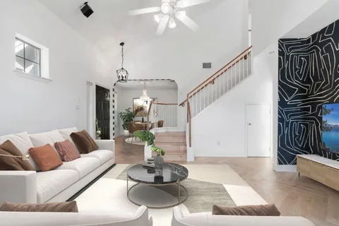 a living room with furniture and wooden floor