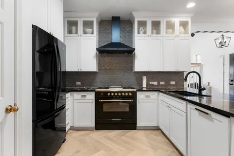 a kitchen with stainless steel appliances granite countertop a stove and a refrigerator