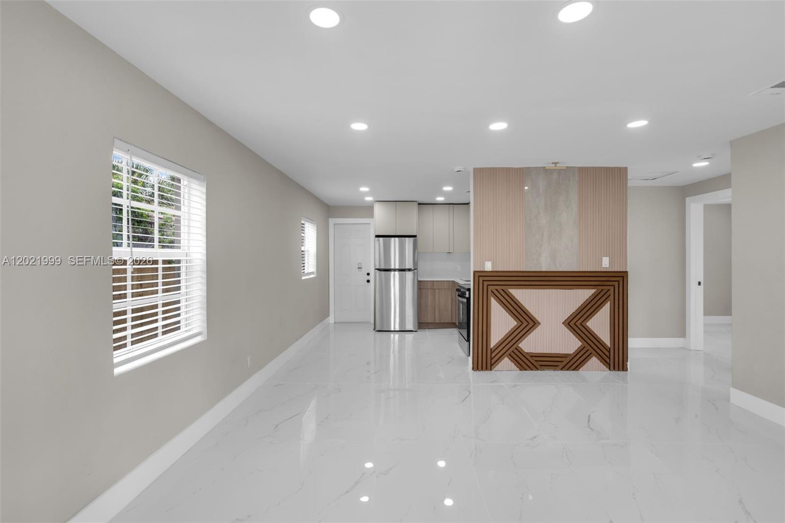 1660 West 26th Street Riviera Beach, FL 33404 - Photo 4 of 28 a view of empty room with wooden floor and windows