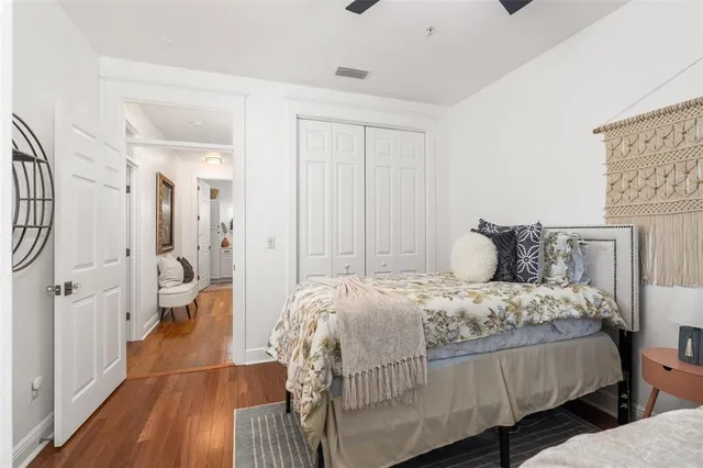 a bedroom with a bed and wooden floor