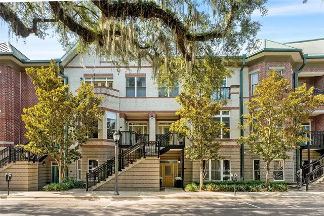 a front view of a building with a garden