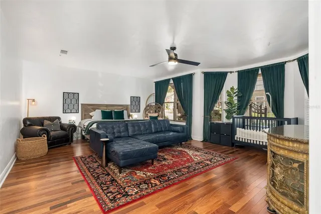 a living room with furniture and a floor to ceiling window