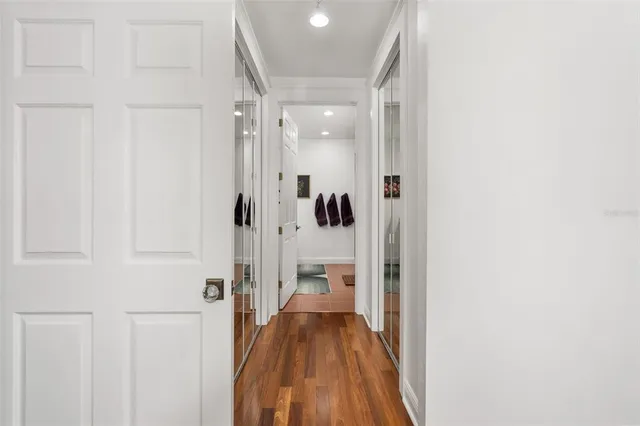 a view of a hallway with a livingroom and furniture