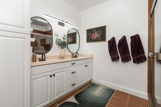 a bathroom with a sink and mirror