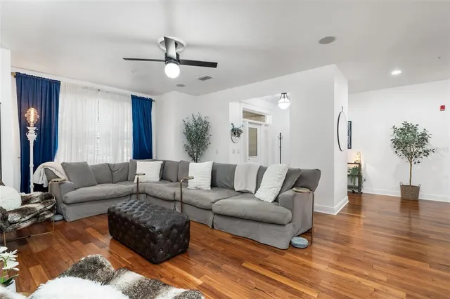 a living room with furniture and a large mirror