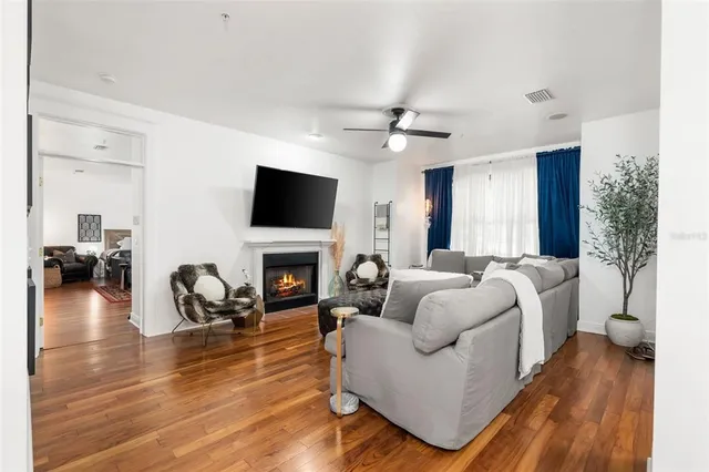a living room with furniture a fireplace and a flat screen tv