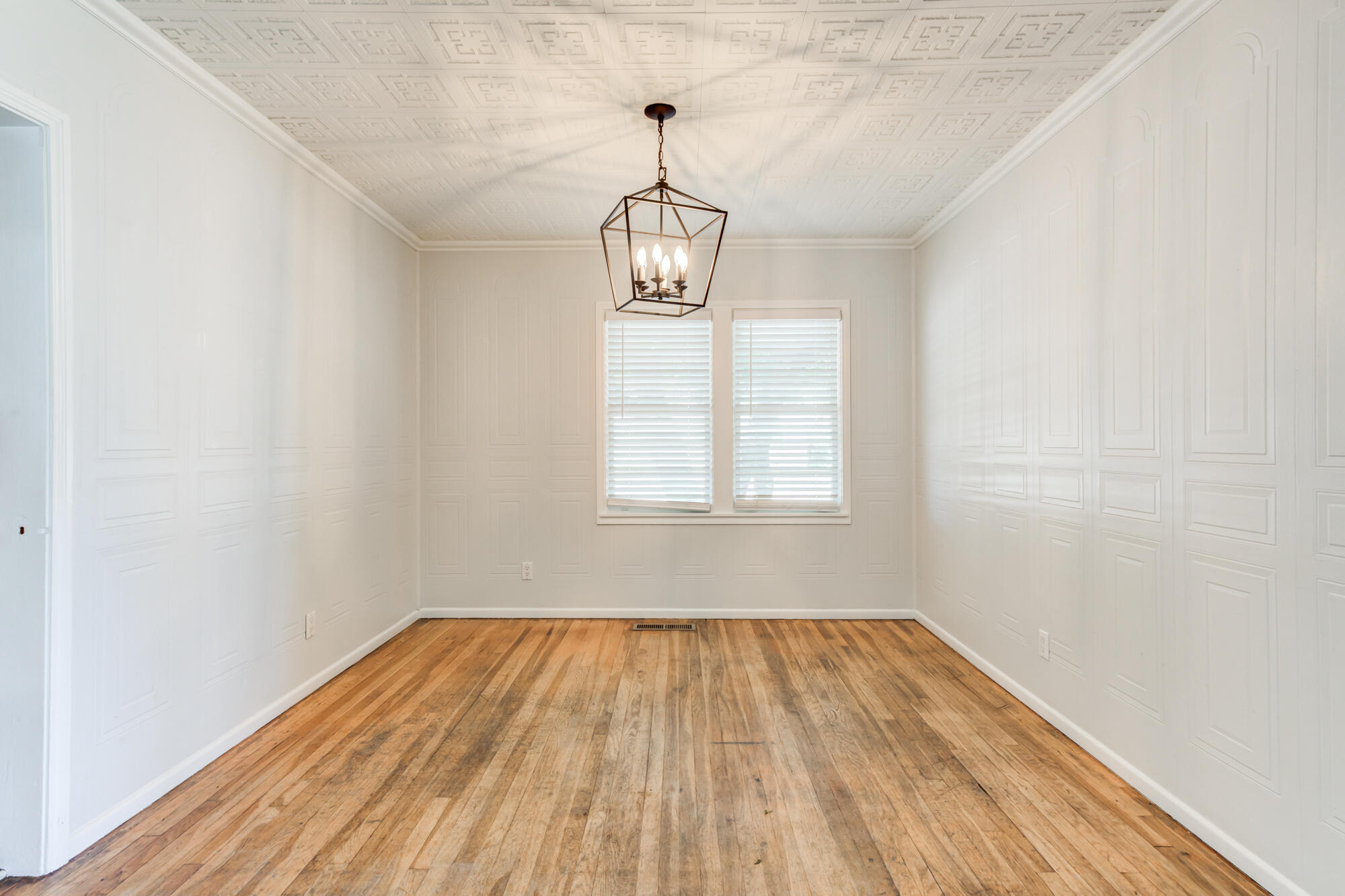 2629 24th Street Lubbock, TX 79410 - Photo 11 of 28 a view of empty room with wooden floor and windows