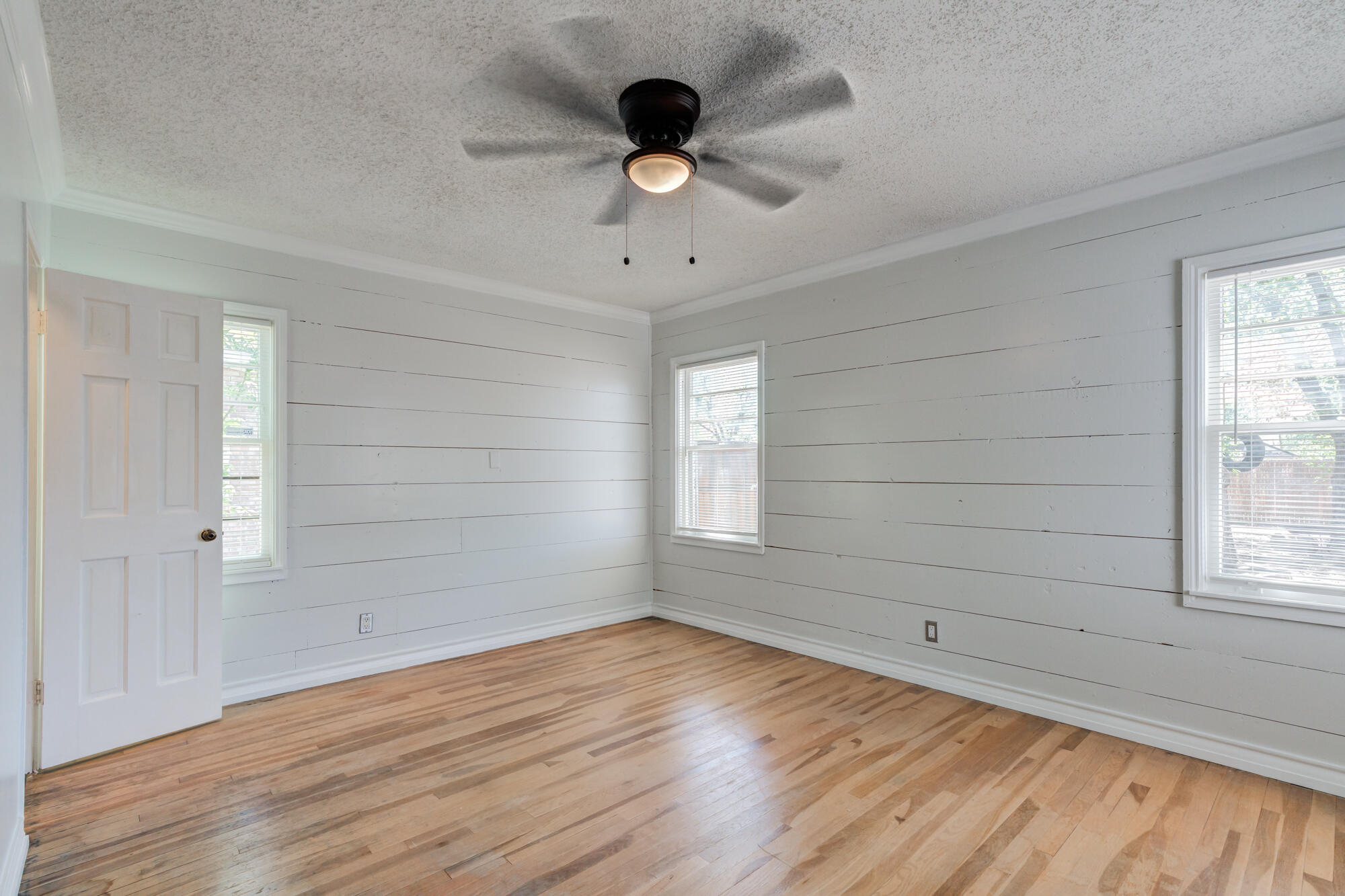 2629 24th Street Lubbock, TX 79410 - Photo 12 of 28 wooden floor in an empty room with a window