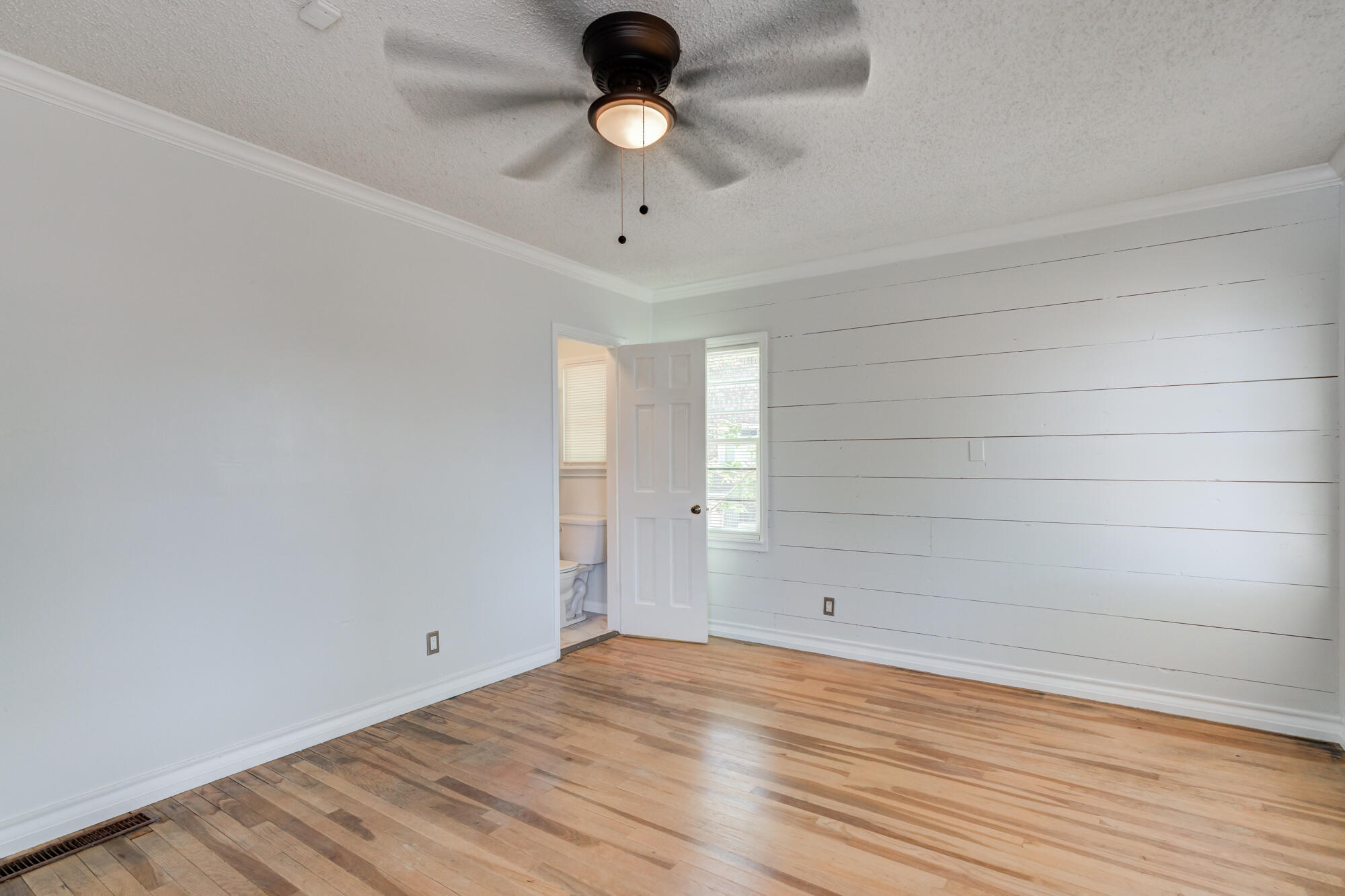2629 24th Street Lubbock, TX 79410 - Photo 13 of 28 a view of empty room with wooden floor and fan
