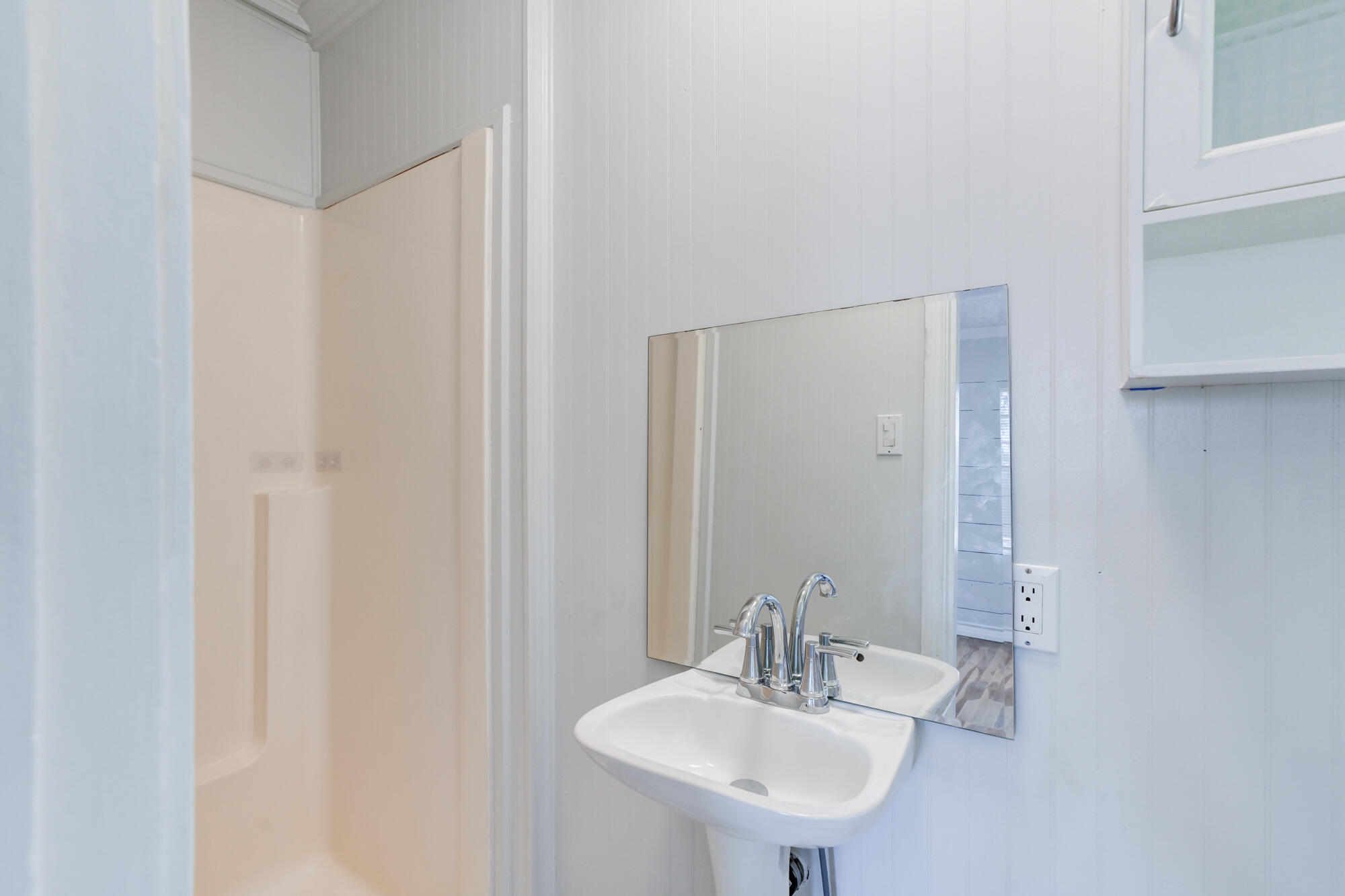 2629 24th Street Lubbock, TX 79410 - Photo 14 of 28 a bathroom with a sink and a mirror