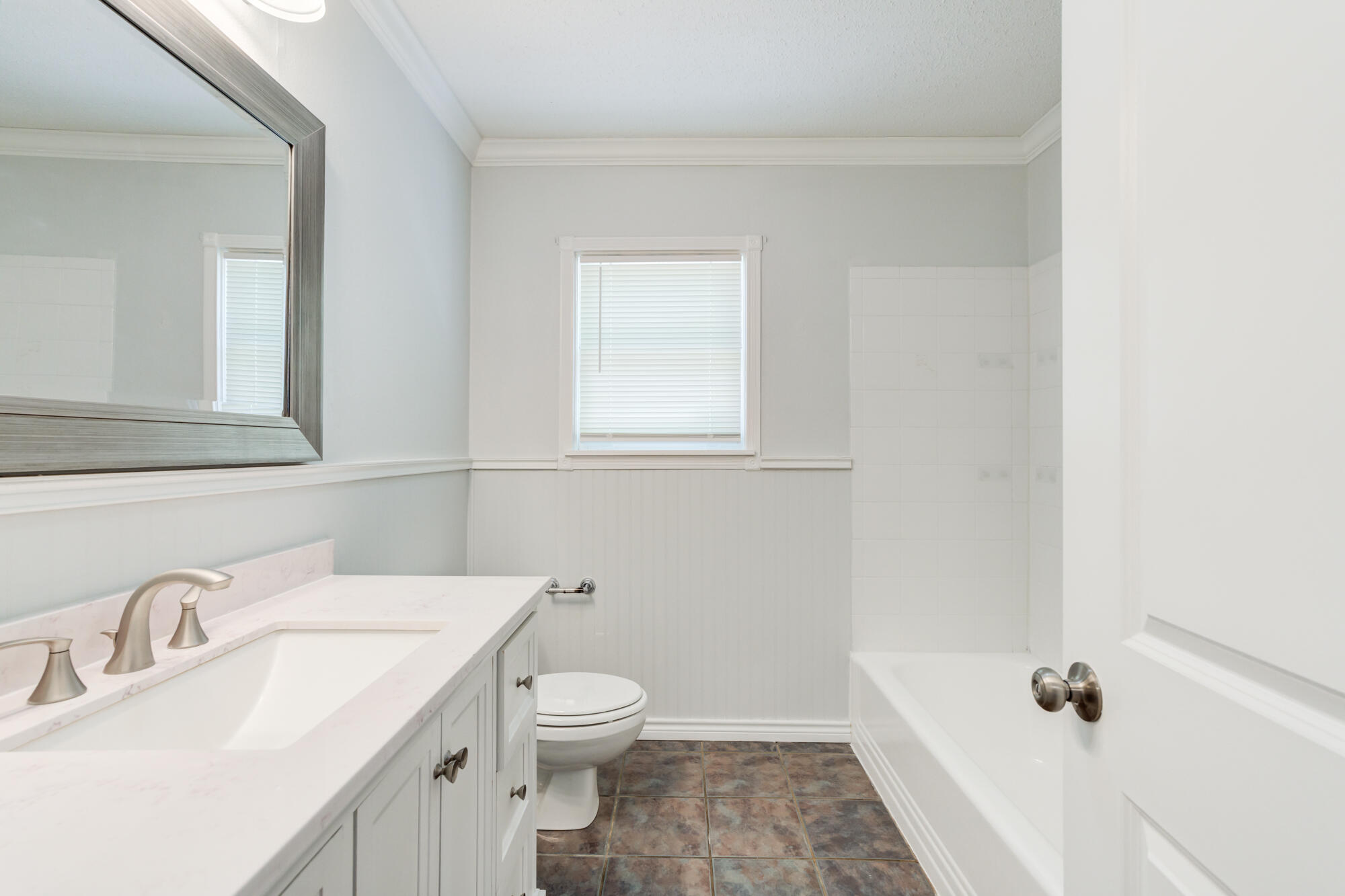 2629 24th Street Lubbock, TX 79410 - Photo 16 of 28 a bathroom with a sink toilet and tub
