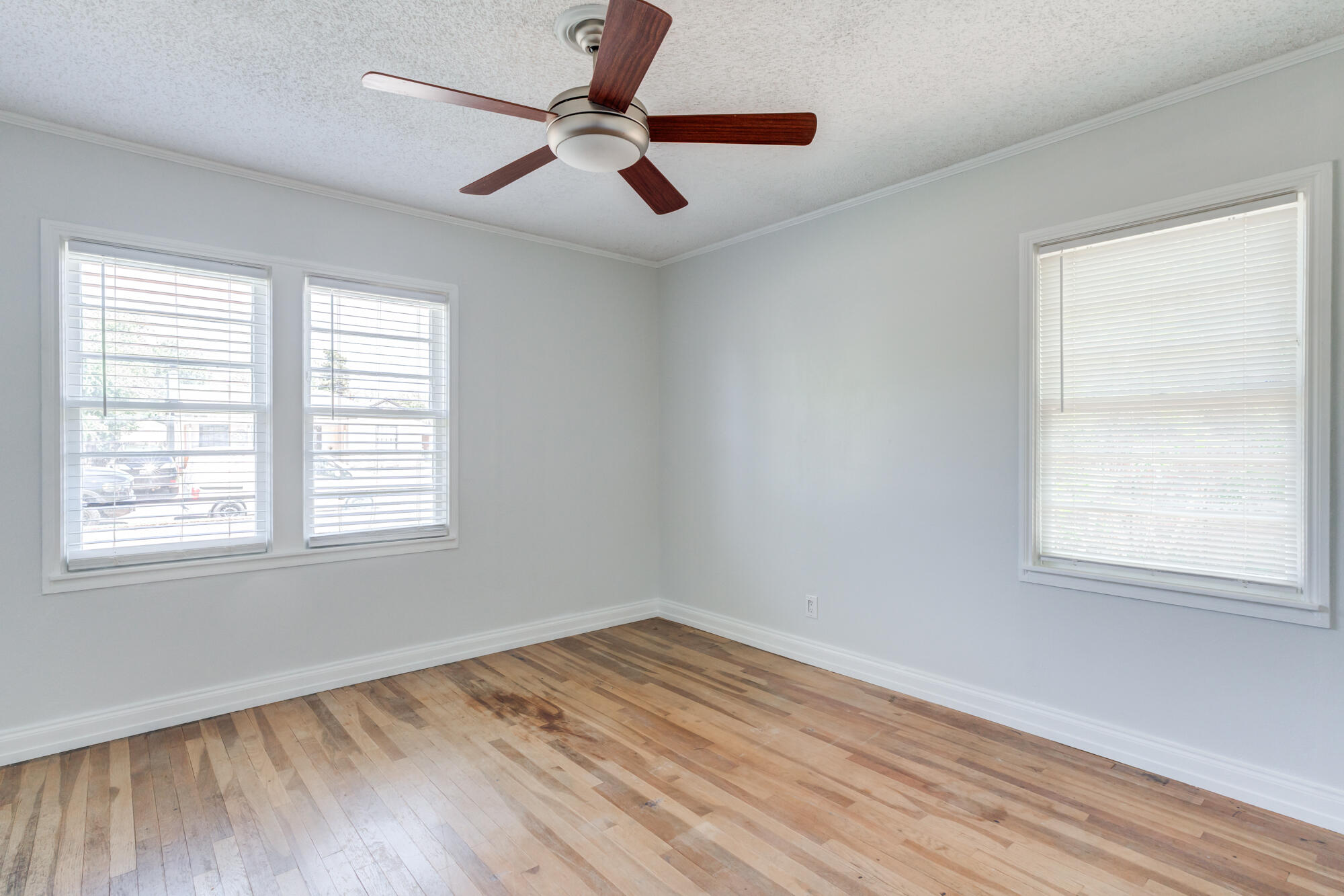 2629 24th Street Lubbock, TX 79410 - Photo 18 of 28 a view of empty room with wooden floor and fan