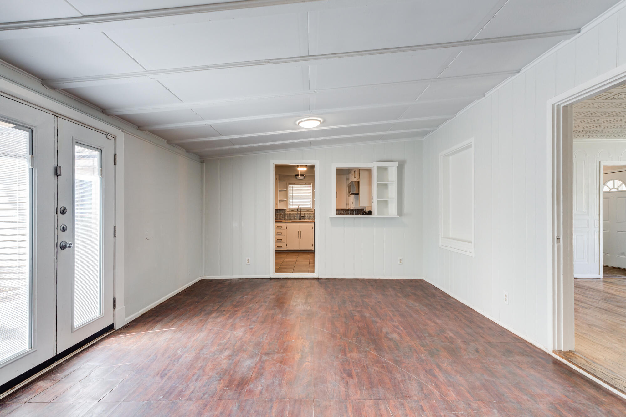 2629 24th Street Lubbock, TX 79410 - Photo 19 of 28 a view of an empty room with wooden floor and a window