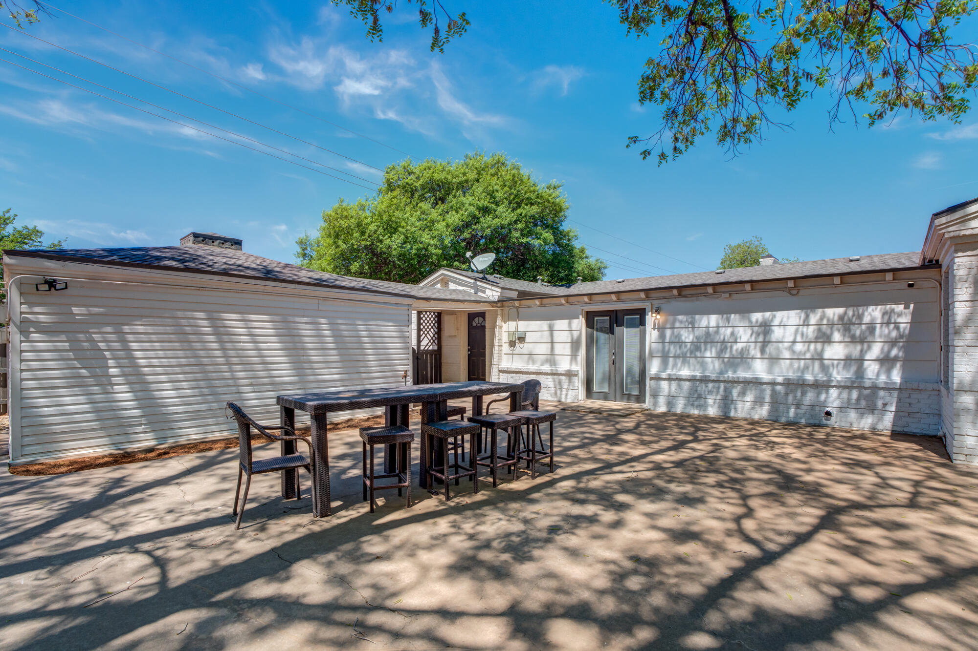 2629 24th Street Lubbock, TX 79410 - Photo 24 of 28 a backyard of a house with yard table and chairs